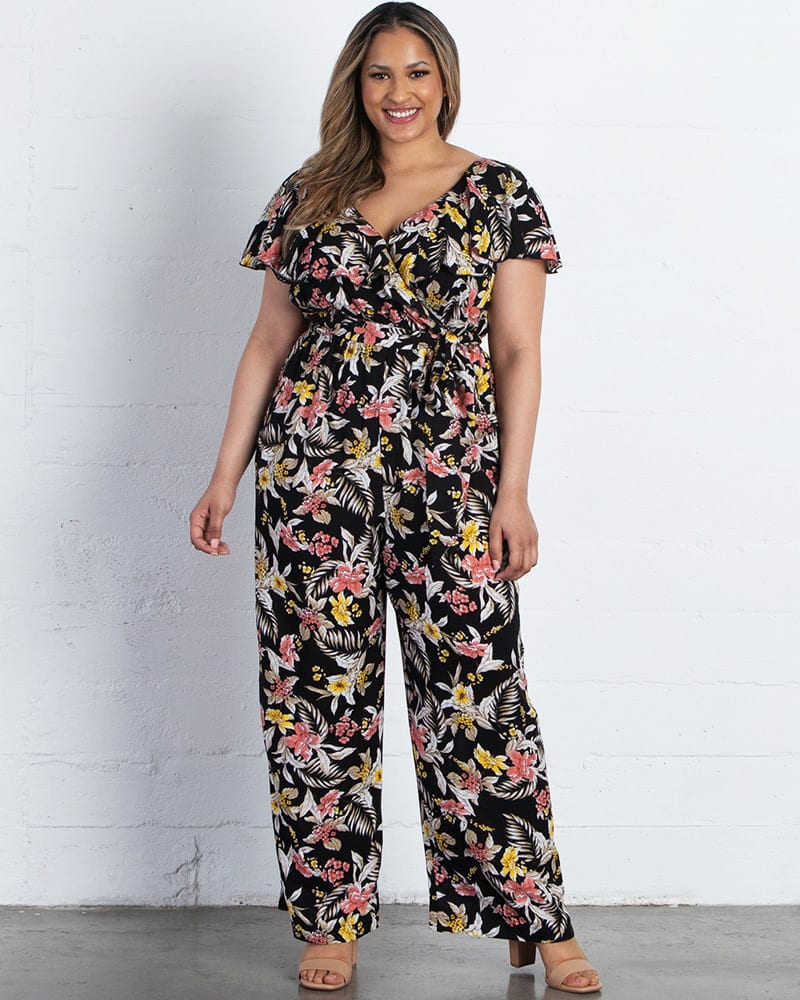 Front of a model wearing a size 0X Odessa Ruffle Jumpsuit in BLACK TROPICAL BLOOMS by Kiyonna. | dia_product_style_image_id:223901